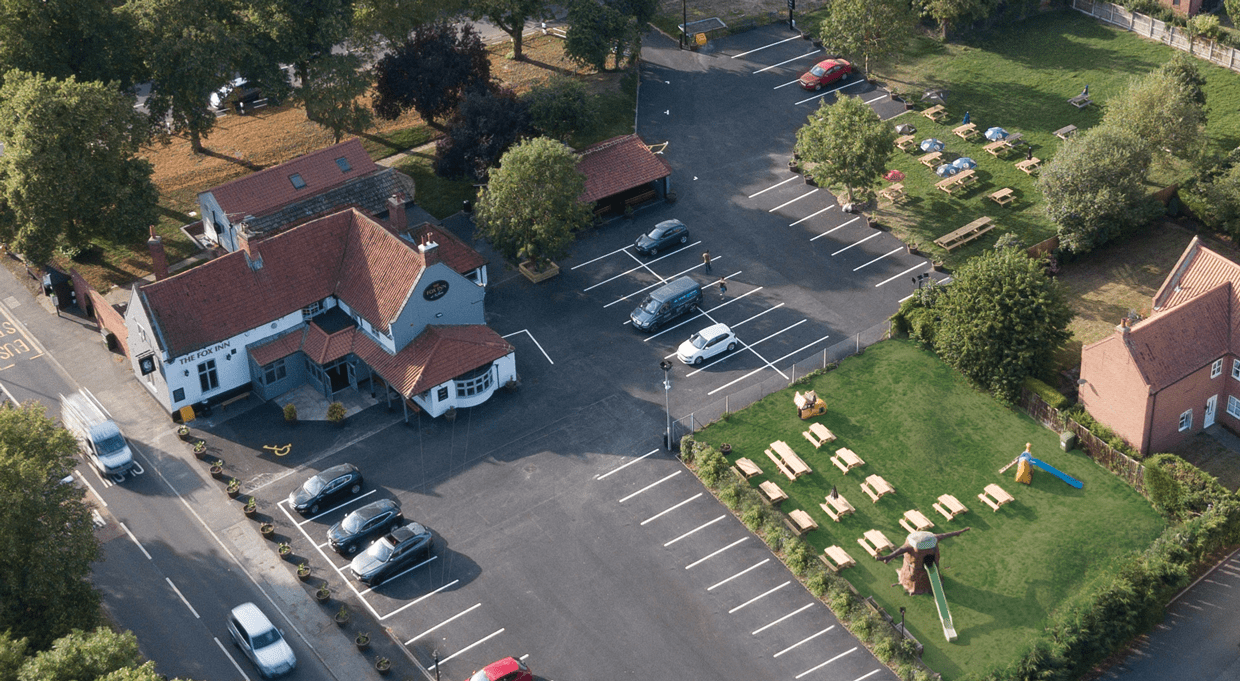 Aerial view of The Fox Inn, with its car park and beer garden